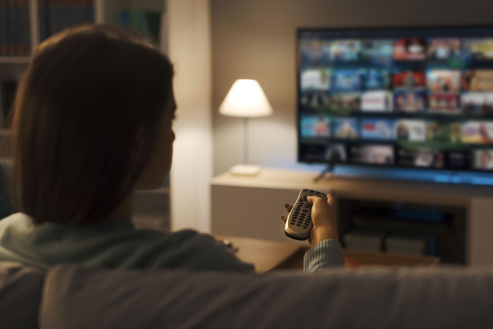 Young woman watching video on demand on her TV social interaction improves health